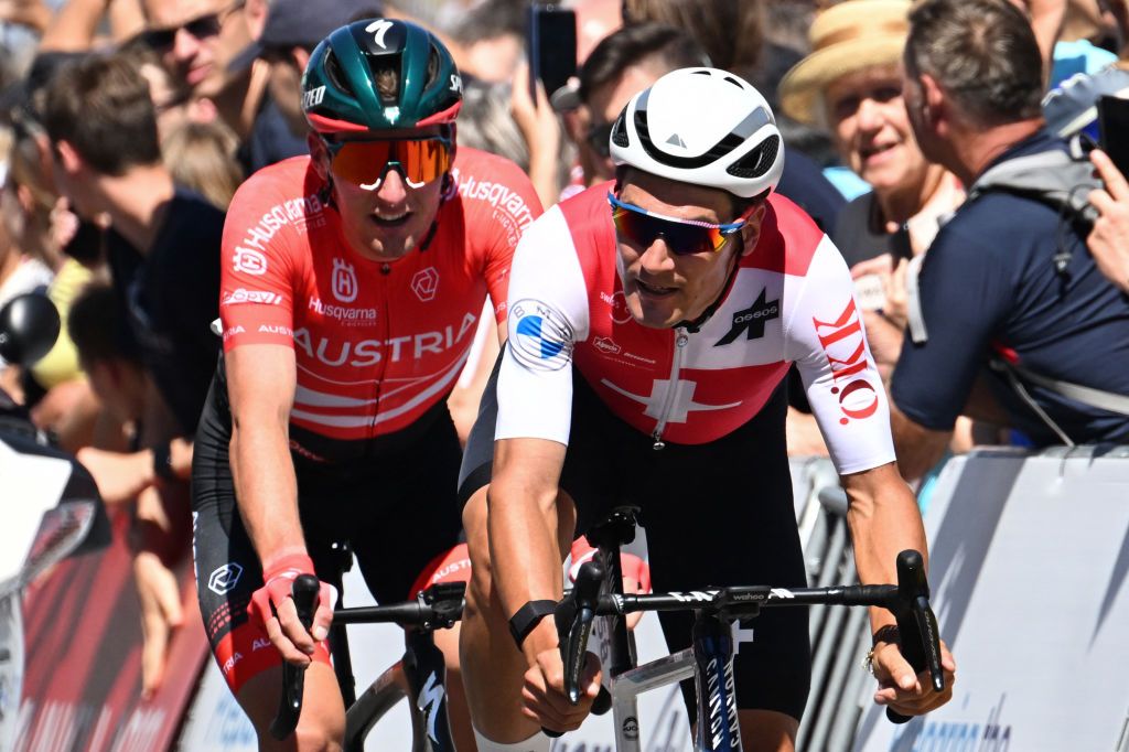 Switzerlands Silvan Dillier R and Austrias Lukas Poestlberger compete during the mens road race cycling event of the European Championships Munich 2022 in Munich southern Germany on August 14 2022 Photo by INA FASSBENDER AFP Photo by INA FASSBENDERAFP via Getty Images