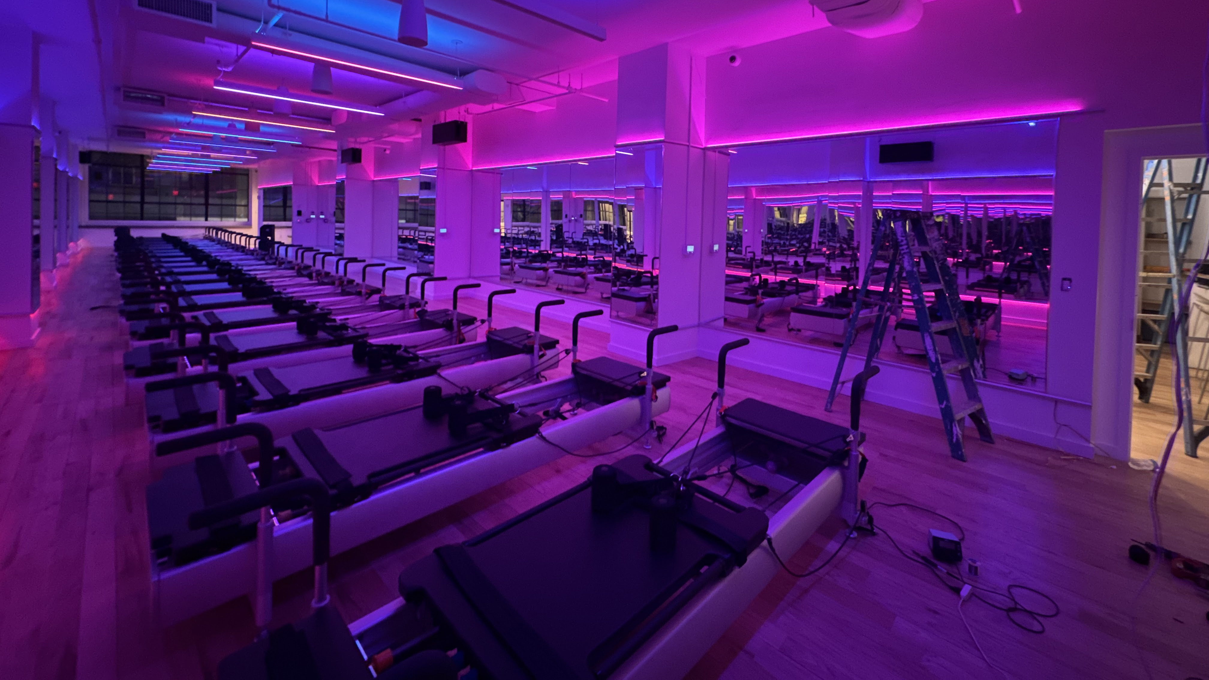 A fitness center, lit in in dark blue and purple hue, gets complete control from ADI | Snap One.