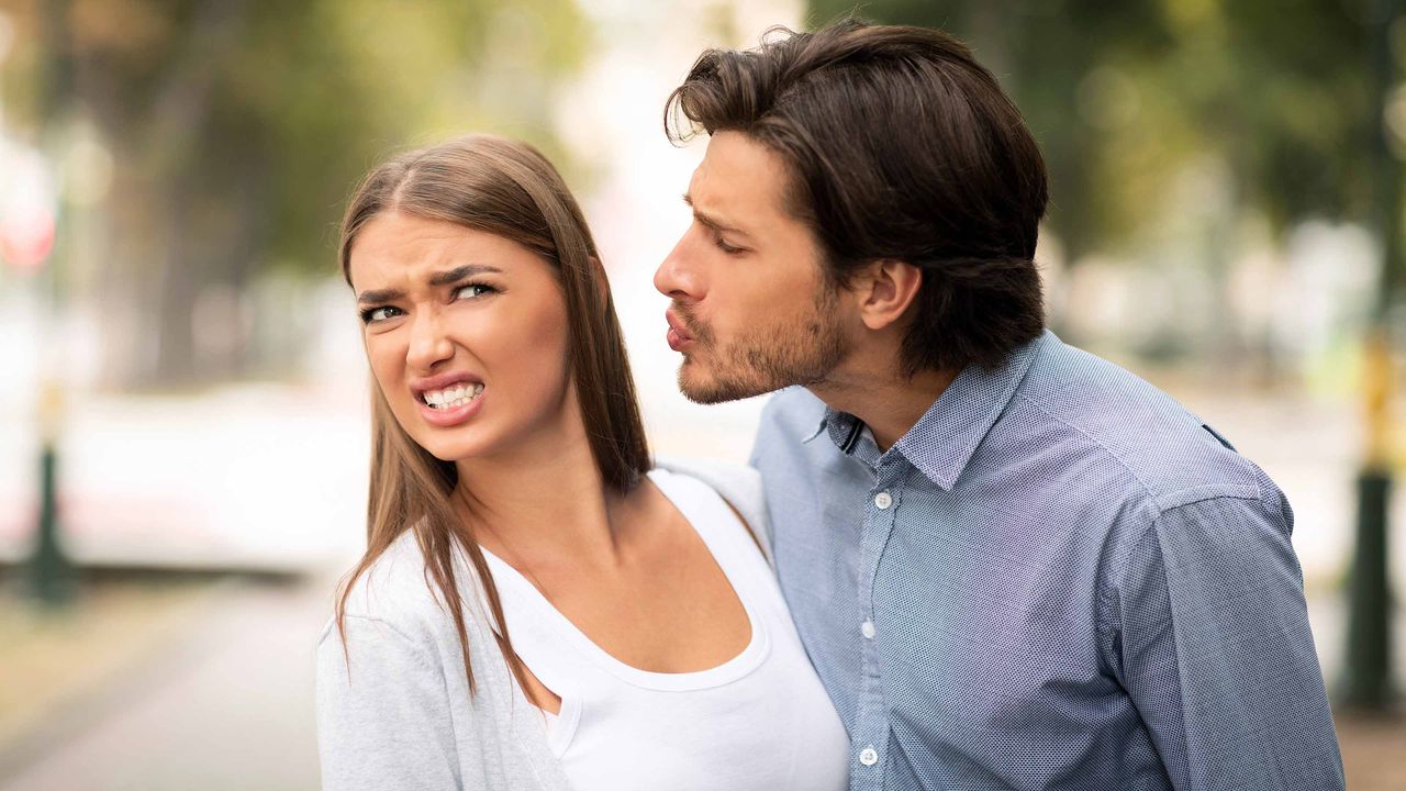 woman avoiding man&amp;#039;s kiss