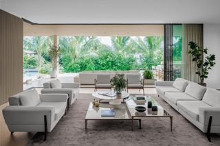 Sunset Island Residence by Strang Design living space interior with large windows