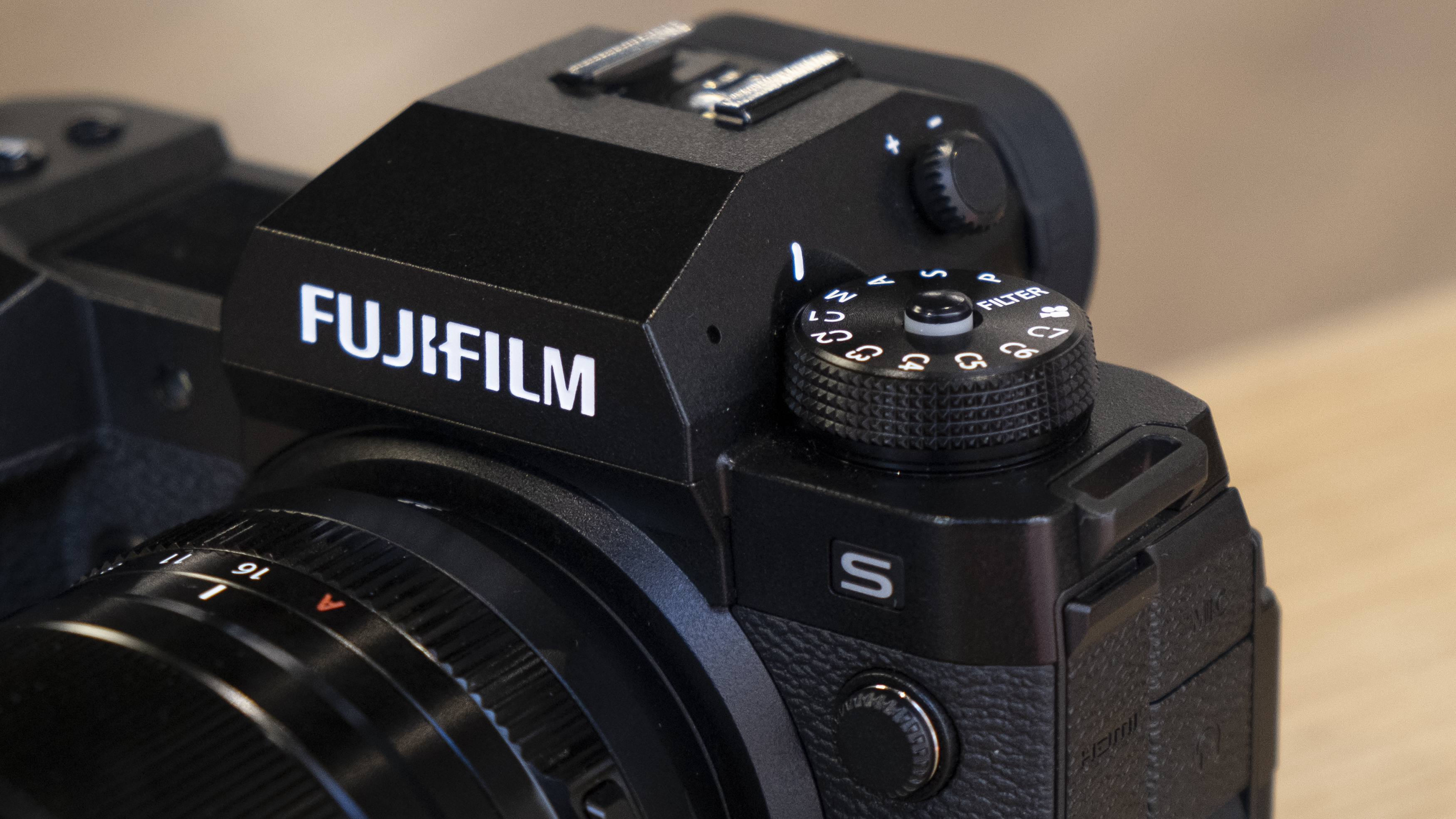 The Fujifilm X-H2S camera on a wooden table