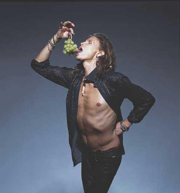 Steven Tyler eating a bunch of grapes - studio portrait