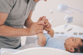 dad changing nappy