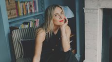 Lucy Williams in her home with blue shelving in the background