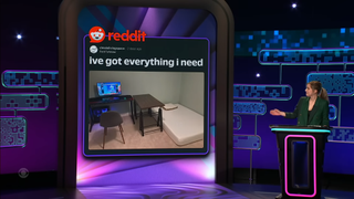 A presenter points at a reddit post on a panel show.