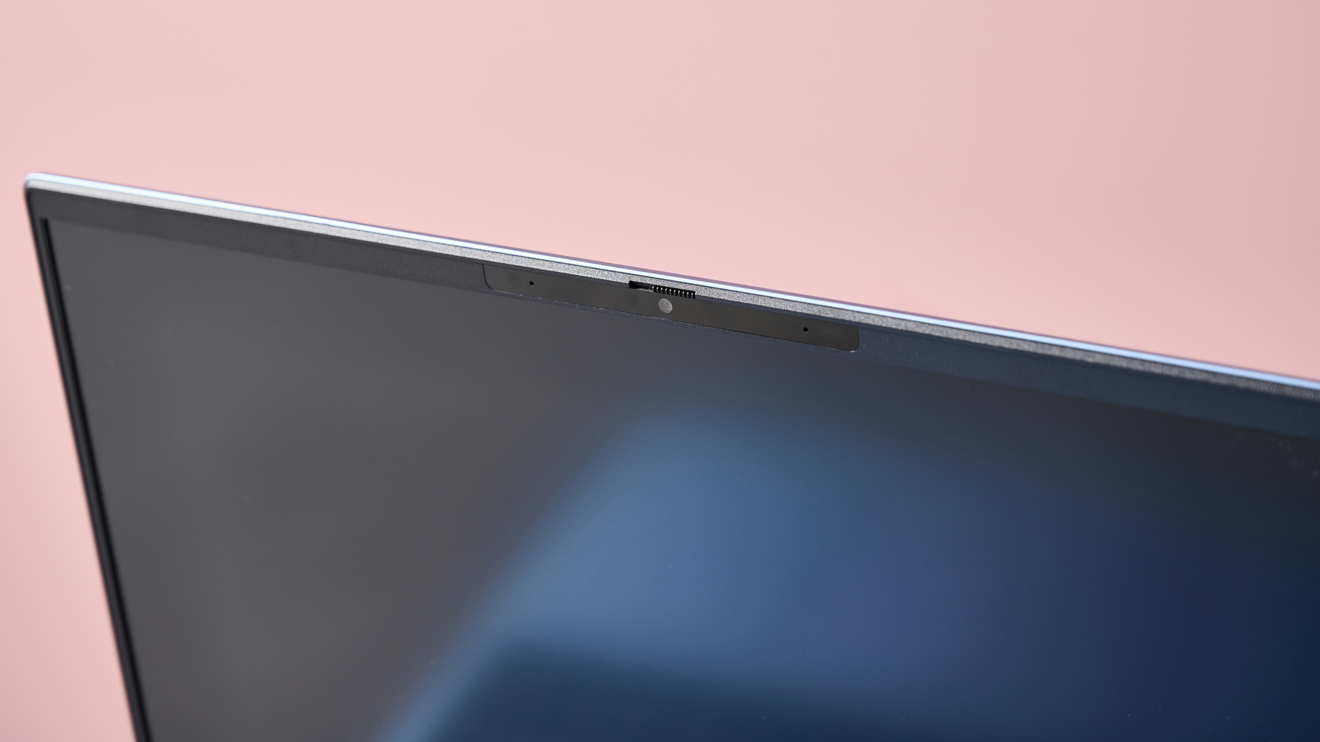 Close-up of webcam on HP Pavilion 16, with pink wall in background