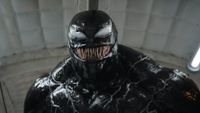 a humanoid creature covered in a thick black goo-like substance with a mouth full of long, sharp teeth