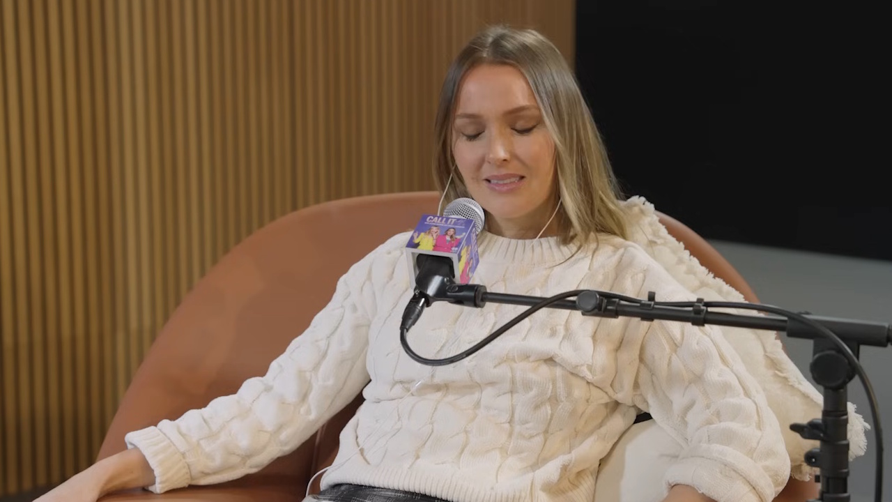 Camilla Luddington closes her eyes and grits her teeth in sorrow as she talks on her Call It What It Is podcast.