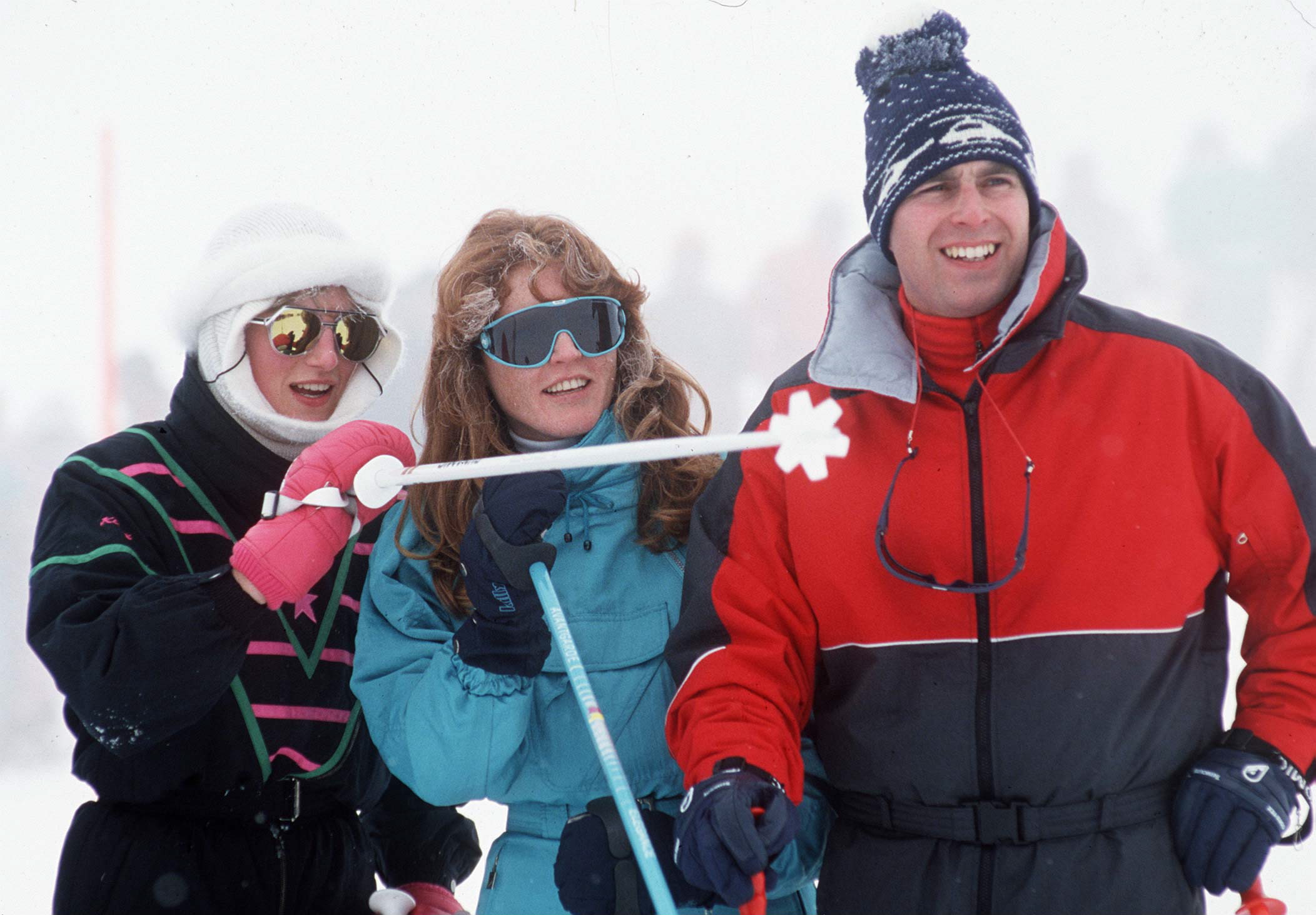 Princess Diana, Sarah Ferguson and Prince Andrew standing in a row with ski gear