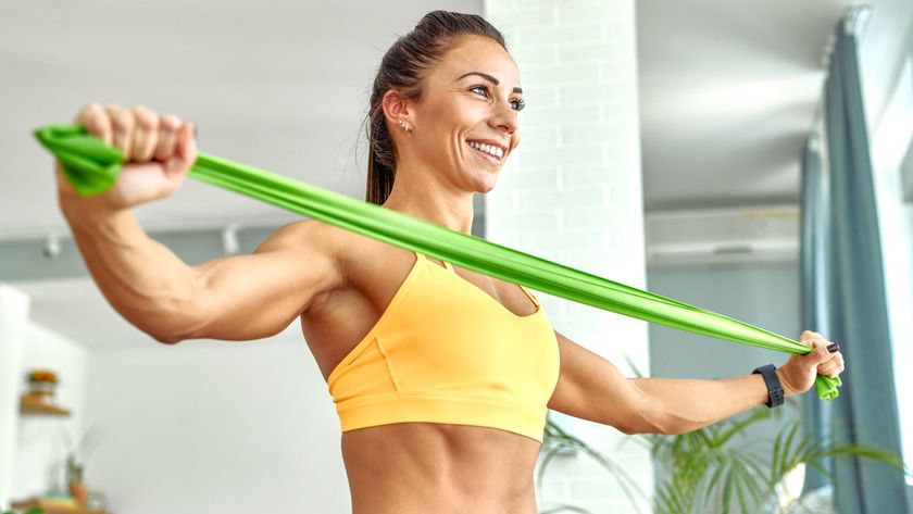 Woman stretching out a resistance band with her arms