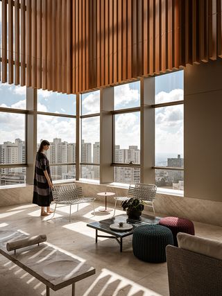 nova lima apartment showing long views and timber interiors with brazilian minimalism