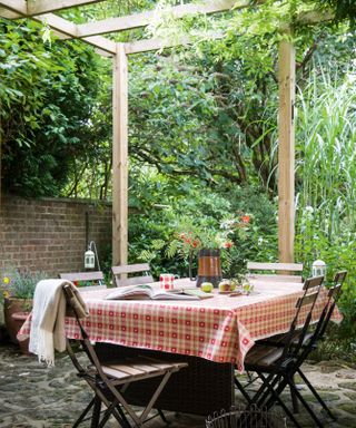 small patio dining area with a pergola