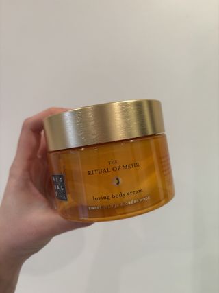 Mica Ricketts holding Rituals The Ritual of Mehr Body Cream