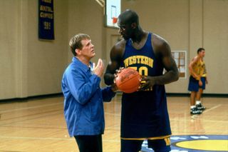 nick nolte and shaq standing on a basketball court in the movie blue chips