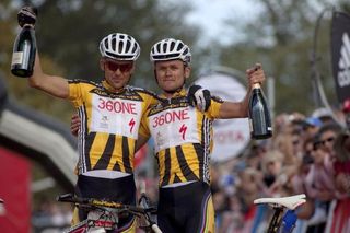 Christoph Sauser and Burry Stander of team 36One Songo-Specialized celebrate the overall win during the final stage (stage 7) of the 2011 Absa Cape Epic mountain bike stage race