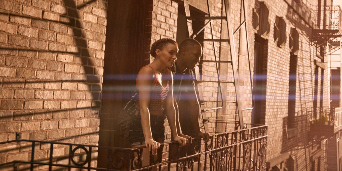 Leslie Grace and Corey Hawkins as Nina and Benny gazing at the sunset in In the Heights