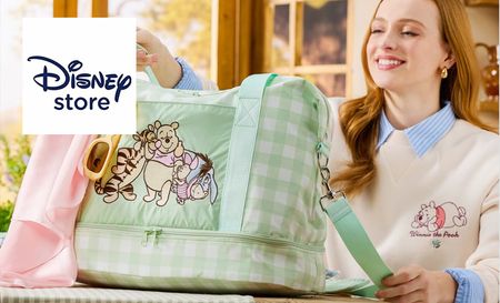 disney store logo top left with a picture of a woman holding a winnie the pooh bag