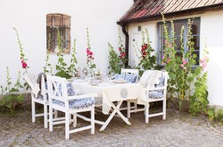 alfresco dining area with table, chairs and crockery