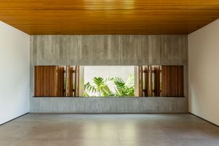 AG House by camila porto, a low brazilian house made of wood and exposed concrete