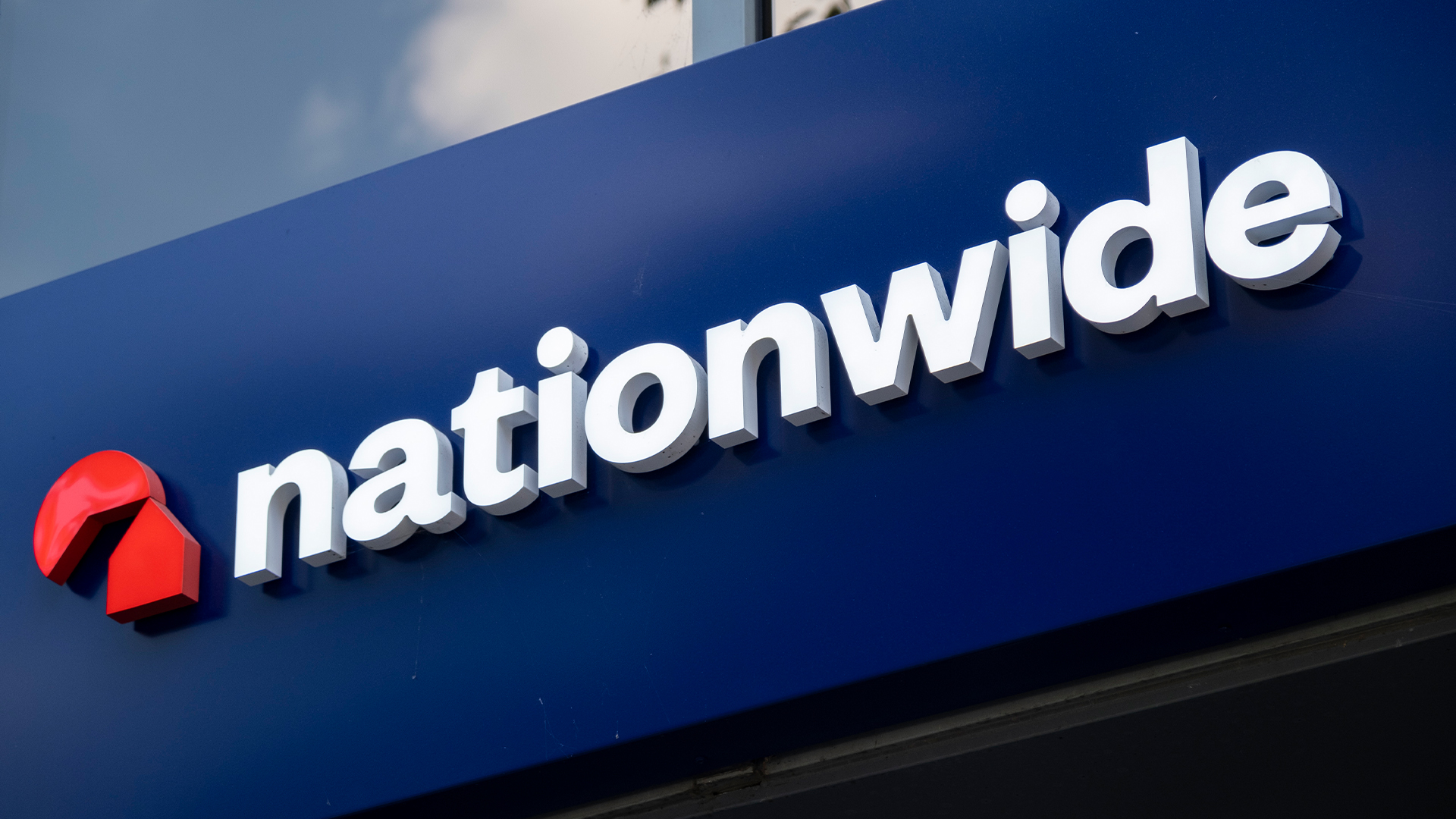 Nationwide Building Society logo and branding pictured on a sign outside branch in London, England.