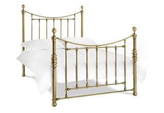 Brass Katherine victorian-style king-sized bed with white bedlinen and pillows