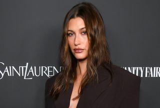 Hailey Bieber wearing an oversize brown suit at the Vanity Fair x Saint Laurent x NBCUniversal Oppenheimer Film Toast held on March 8, 2024, in Los Angeles, California.