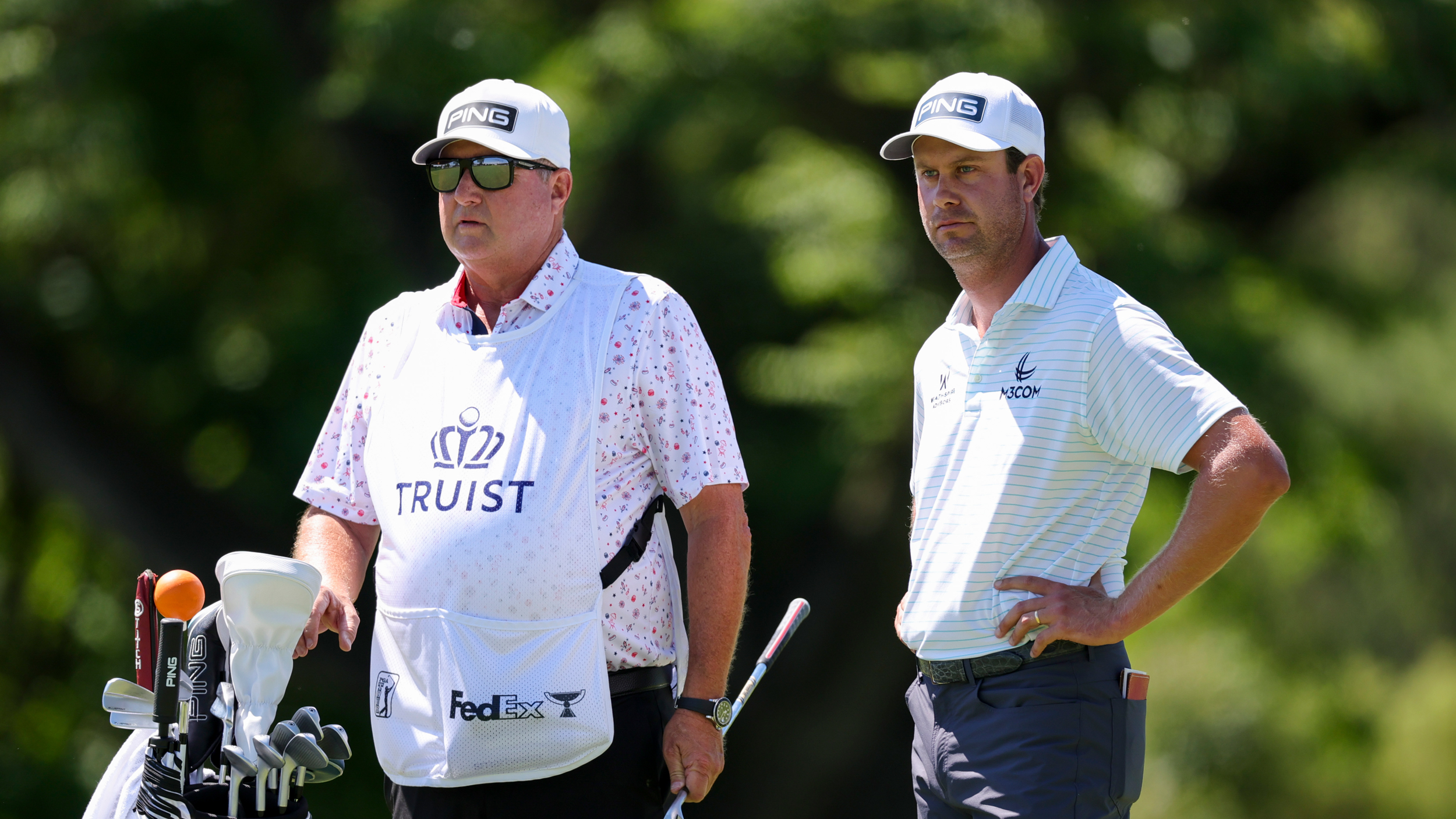 Harris English (right) and his caddie, Eric Larson weigh up a shot during the Truist Championship in 2025