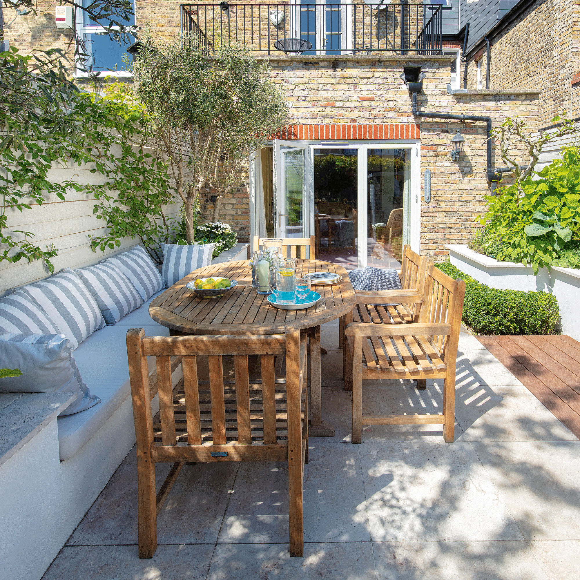 Wooden table in small concrete garden