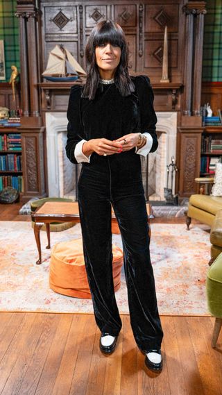 Claudia Winkleman wearing a black velvet jumpsuit