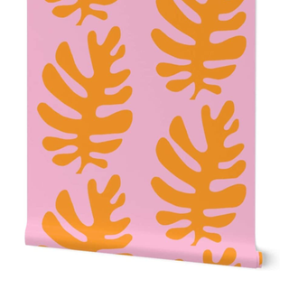 A roll of pink and orange peel and stick wallpaper with Matisse-style leaf motif