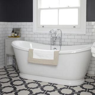 bathroom with printed tiled flooring and white bathtub