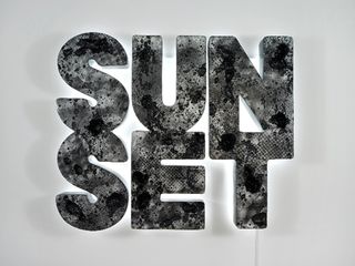 'Sunset (black)', 2013, is made from hand-carved foam and epoxy, with LED lights and hand-silk-screened acrylic