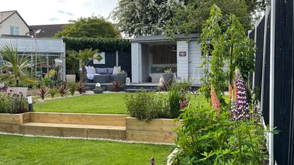 Garden with lawn, raised planters and shed