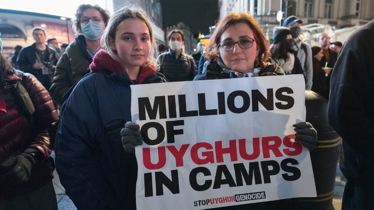 A demonstrator holds a placard in support of the persecuted Uyghur Muslims 