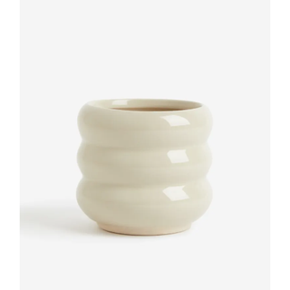 candle in a beige glazed stoneware pot