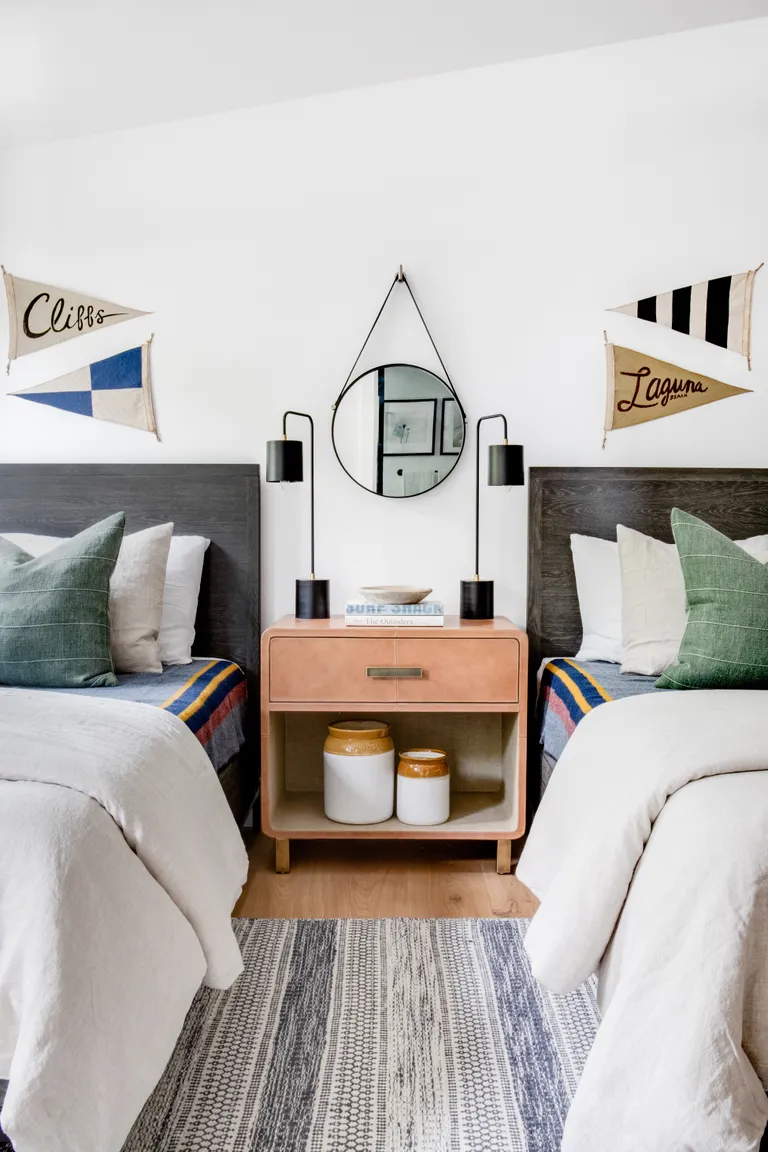 A shared kids bedroom with personalized name tags above the bed