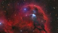 a bright red cloud of dust on a starry background
