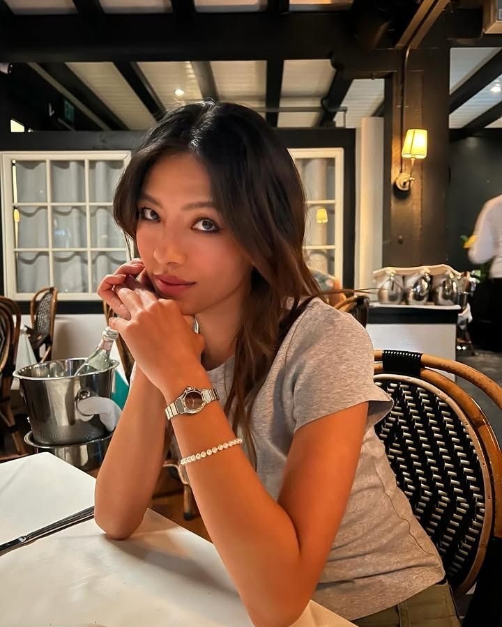 Lily Muni He sitting at a restaurant.