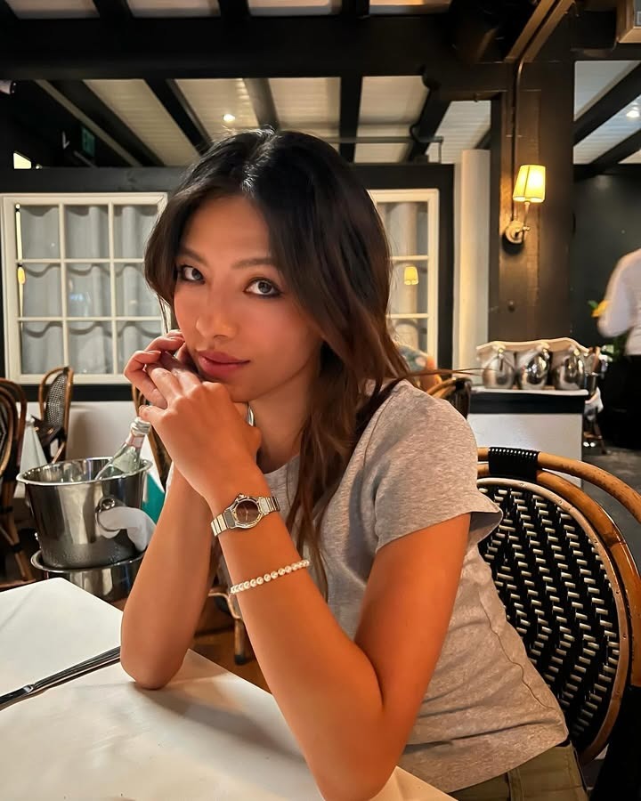 Lily Muni He sitting at a restaurant.