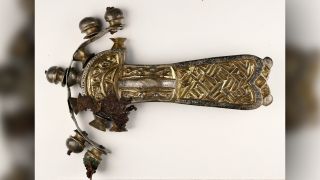 The buckle after conservation, with textile remnants visible on the head. 