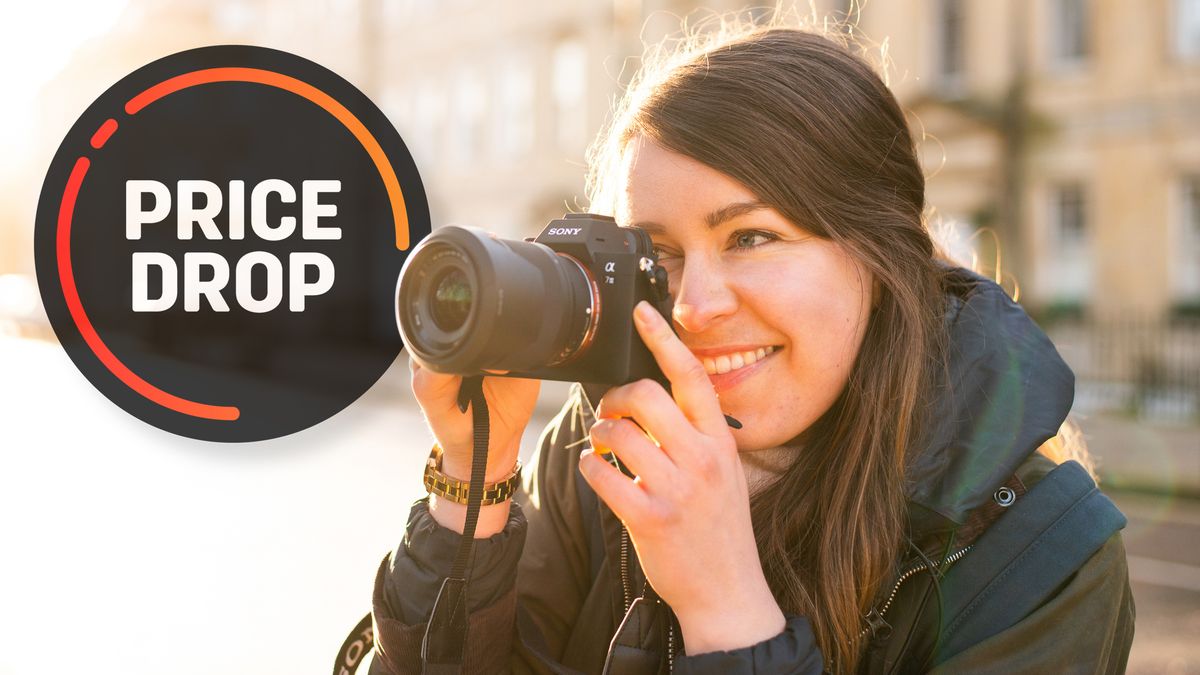 A female photographer using the Sony A7 III in a brightly lit street at sundown, with the text &quot;Price drop&quot;