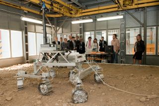 Onlookers watch a demonstration of a prototype Mars rover for the European Space Agency's ExoMars 2018 mission during a 2010 industry presentation in Turin, Italy.