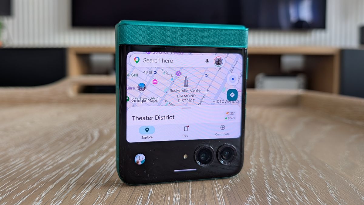 Motorola Razr 2026 in blue, being held in the hand