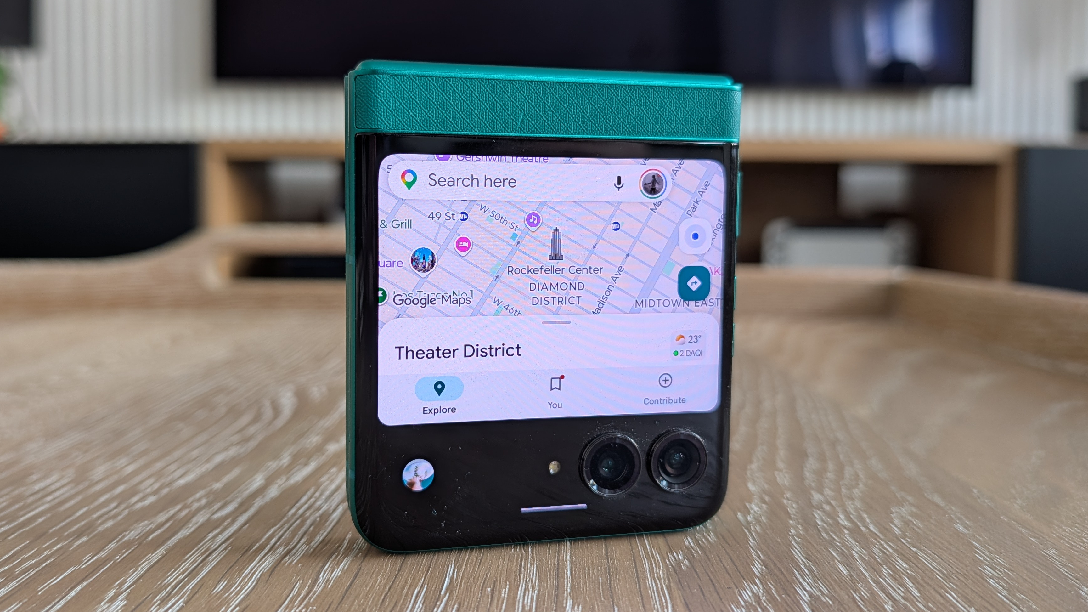 Motorola Razr 2026 in blue, being held in the hand