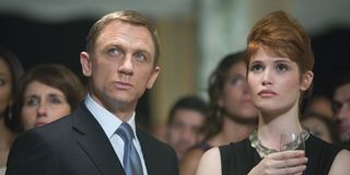 Quantum of Solace Daniel Craig and Gemma Artherton listening intently at a party