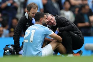 Rayan Ait-Nouri receives treatment following an injury during Manchester City's defeat to Tottenham