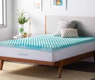 Linenspa Egg Crate Mattress Topper on a bed against a white wall.