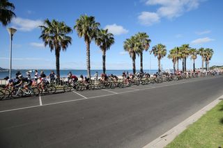 The peloton races past