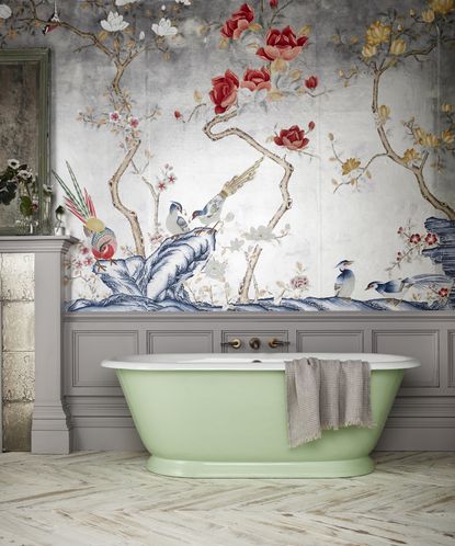 Glossy bathroom with large green bath tub and ornate paper