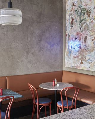An image of the restaurant with table , a lamp and painted wall
